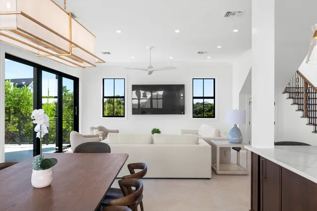 a living room with furniture a window and a potted plant