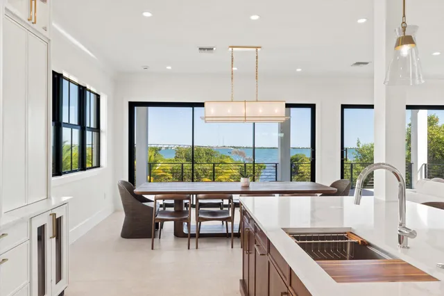 a kitchen with stainless steel appliances granite countertop sink stove and white cabinets