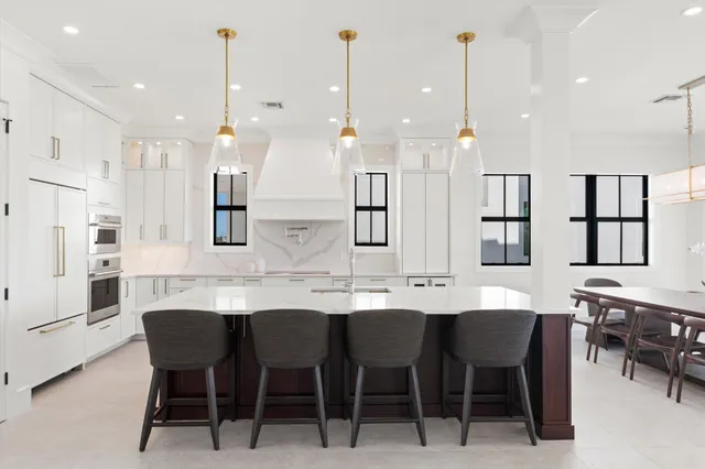 a large kitchen with a table and chairs