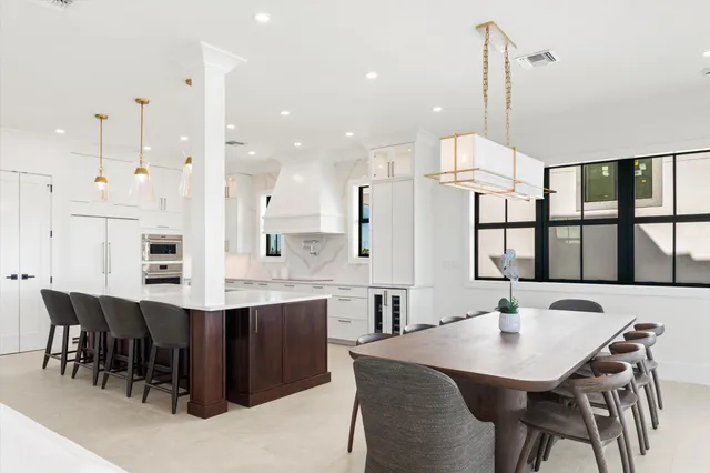 a large kitchen with a table and chairs