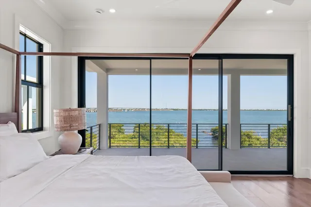 a spacious bedroom with a large window and a bed