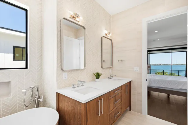a bathroom with a double vanity sink toilet and mirror