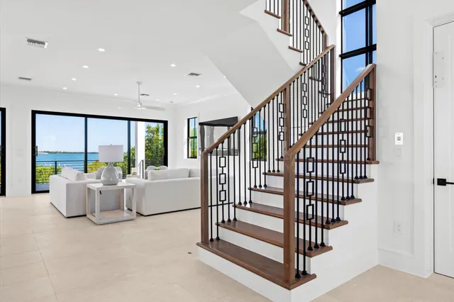 a view of staircase with furniture and floor to ceiling window