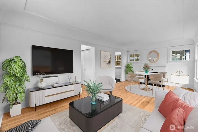 a living room with furniture flat screen tv and a potted plant