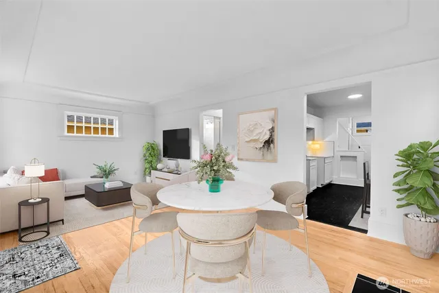 a living room with furniture a flat screen tv and a large window