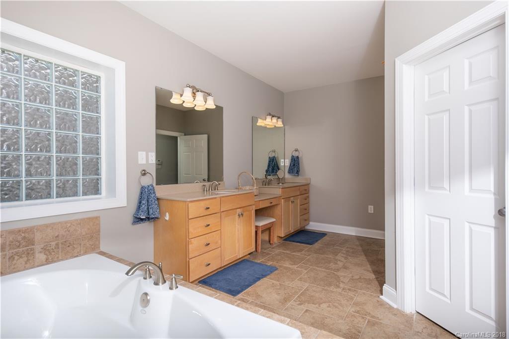 1334 Crown Ridge Drive Fort Mill, SC 29708 - Photo 13 of 25 a spacious bathroom with a tub sink and mirror