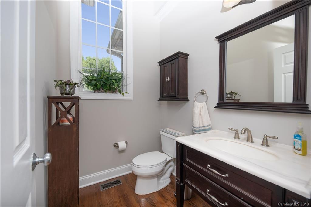 1334 Crown Ridge Drive Fort Mill, SC 29708 - Photo 14 of 25 a bathroom with a granite countertop toilet sink and mirror