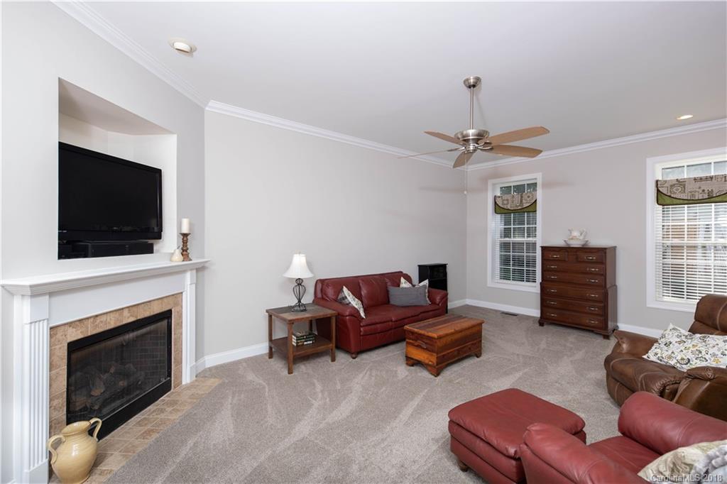 1334 Crown Ridge Drive Fort Mill, SC 29708 - Photo 3 of 25 a living room with furniture a fireplace and a flat screen tv