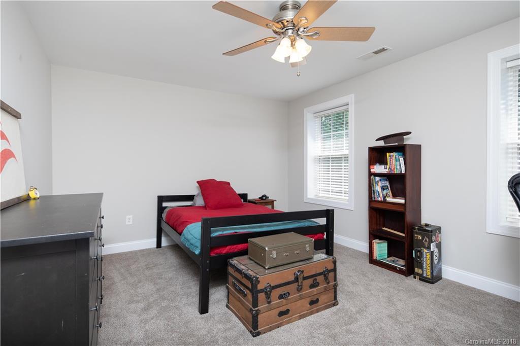 1334 Crown Ridge Drive Fort Mill, SC 29708 - Photo 22 of 25 a living room with furniture and a baby crib