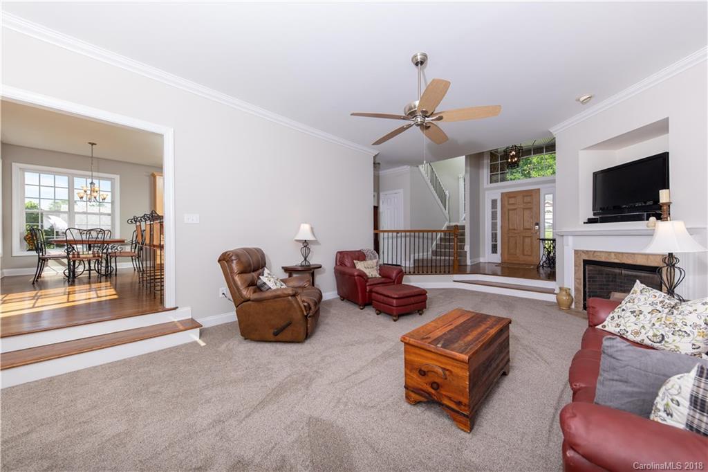 1334 Crown Ridge Drive Fort Mill, SC 29708 - Photo 4 of 25 a living room with furniture a flat screen tv and a fireplace