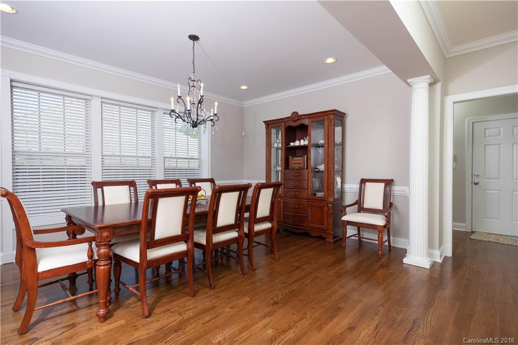1334 Crown Ridge Drive Fort Mill, SC 29708 - Photo 9 of 25 a view of a dining room with furniture wooden floor and chandelier