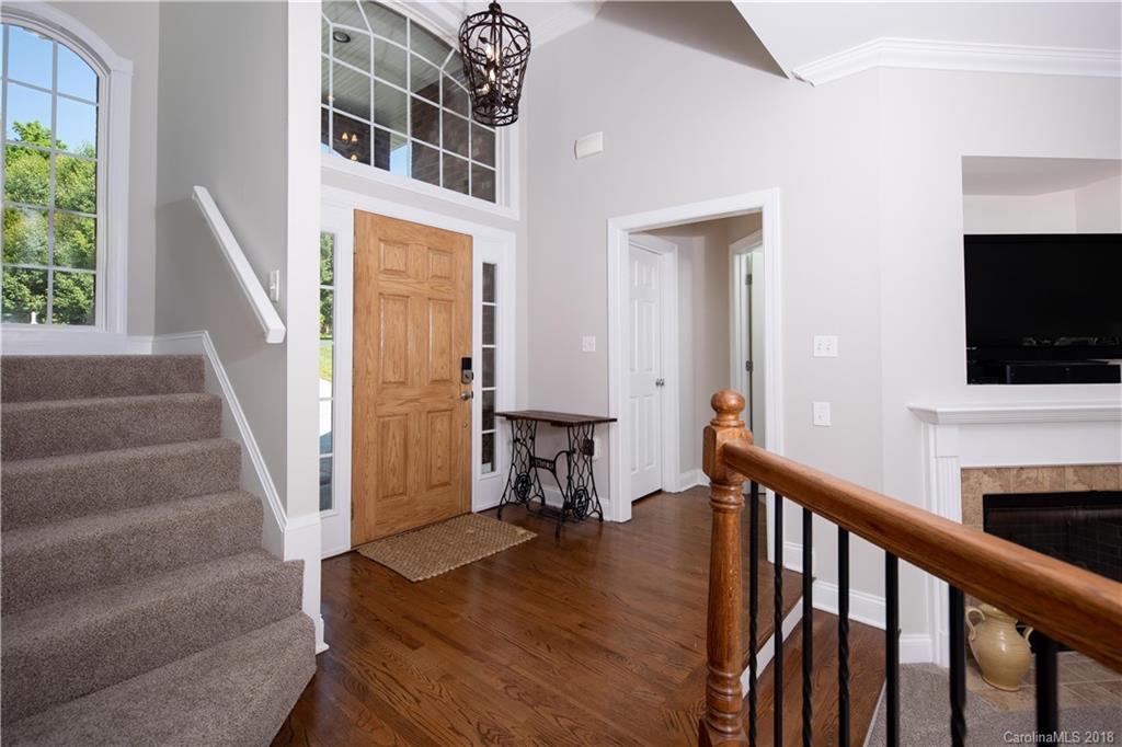 1334 Crown Ridge Drive Fort Mill, SC 29708 - Photo 10 of 25 a view of a hallway with wooden floor and staircase