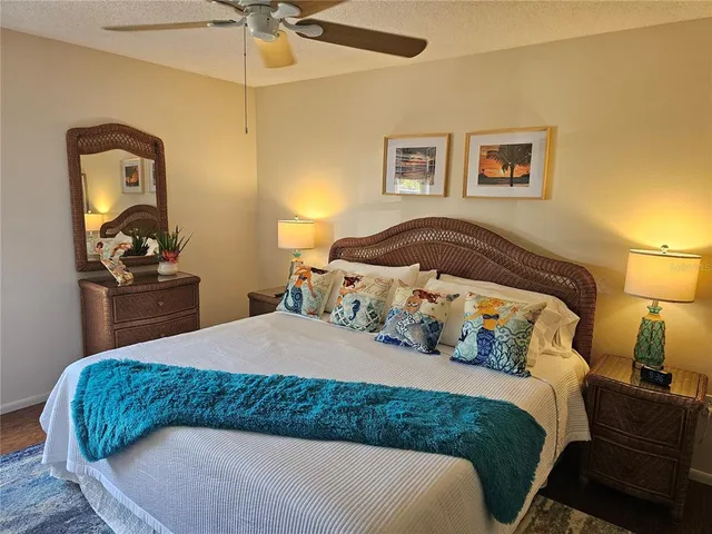 a bedroom with a bed dresser and a flat tv screen