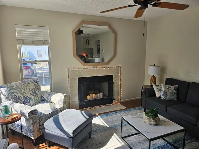 a living room with furniture and a fireplace