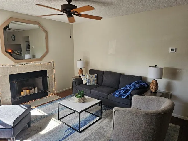 a living room with furniture and a fireplace