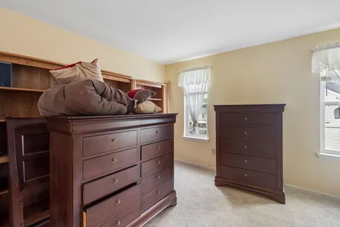 a kitchen with stainless steel appliances granite countertop a refrigerator a sink dishwasher a stove and white countertops with wooden floor