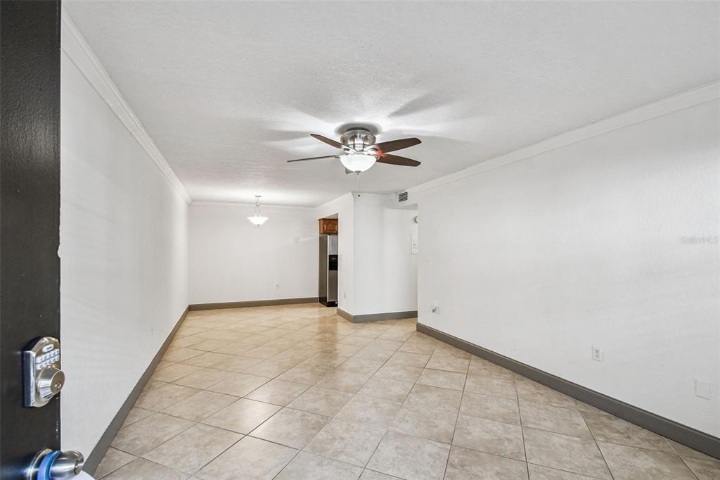 5221 Bayshore Boulevard, Unit 21 Tampa, FL 33611 - Photo 4 of 21 an empty room with a ceiling fan and a window