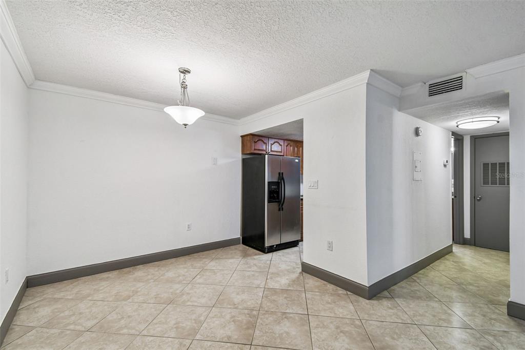 5221 Bayshore Boulevard, Unit 21 Tampa, FL 33611 - Photo 7 of 21 a view of a hallway with closet and a chandelier fan