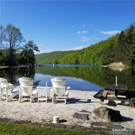 a view of a lake with lawn chairs