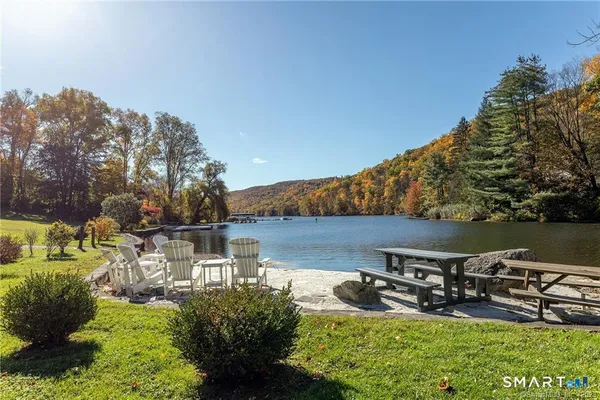 a view of a lake with a car parked on the road