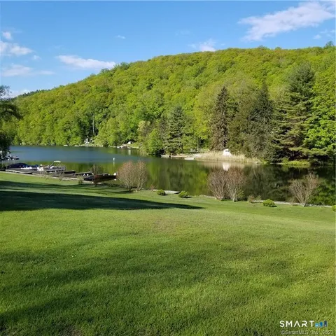 a view of a lake with chairs