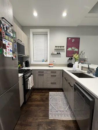 a kitchen with stainless steel appliances kitchen island granite countertop a sink counter space cabinets and a sink