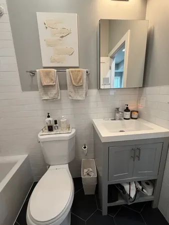 a bathroom with a sink mirror and toilet