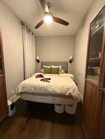a large bed sitting in a bedroom next to a window