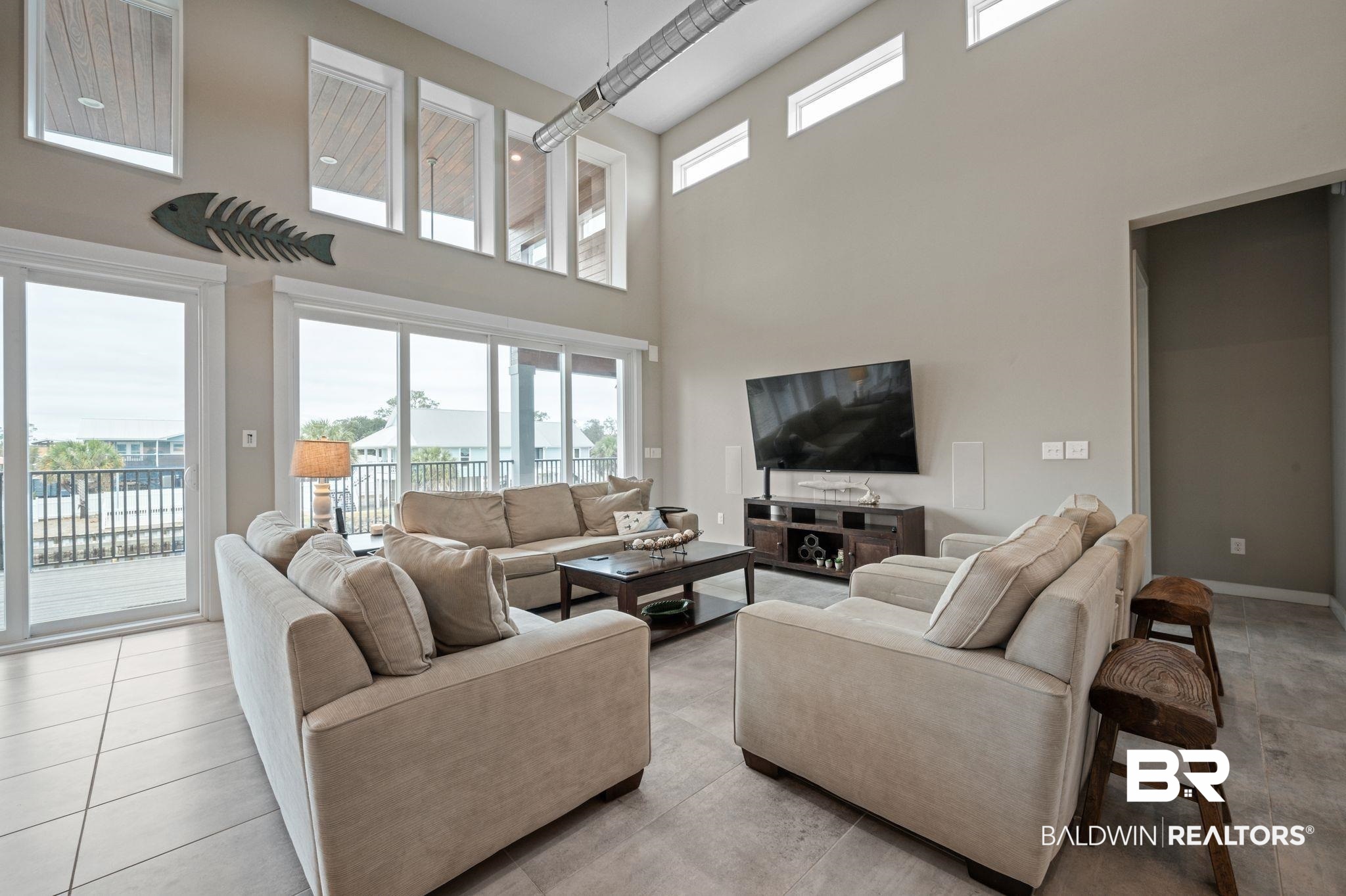 3840 Cotton Way Orange Beach, AL 36561 - Photo 4 of 75 Living room with light tile patterned floors and a high ceiling