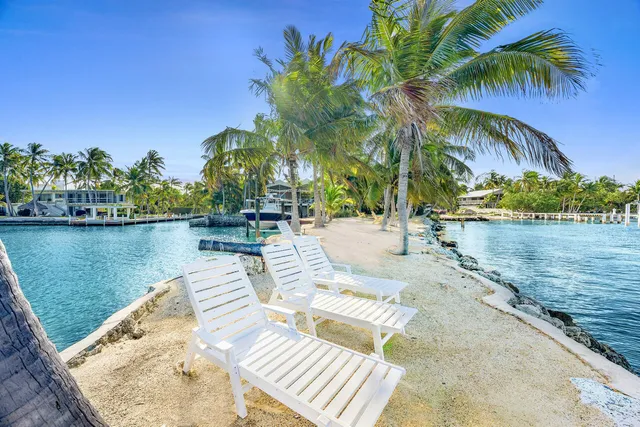 a kitchen with a table chairs stove and cabinets