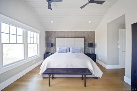 a bedroom with a bed a window and walk in closet
