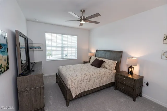 a bedroom with a bed window and a couch