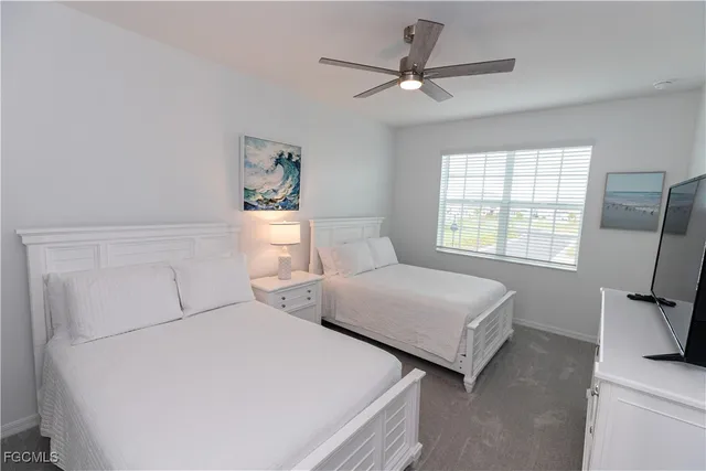 a bedroom with two beds and a window