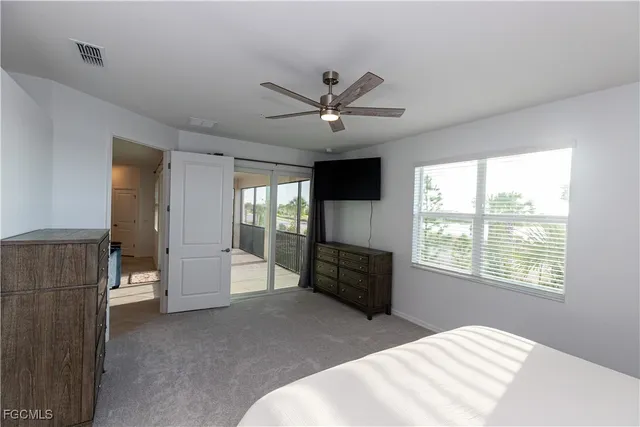 a bedroom with a bed and a large window