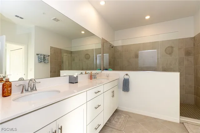 a bathroom with a double vanity sink mirror and