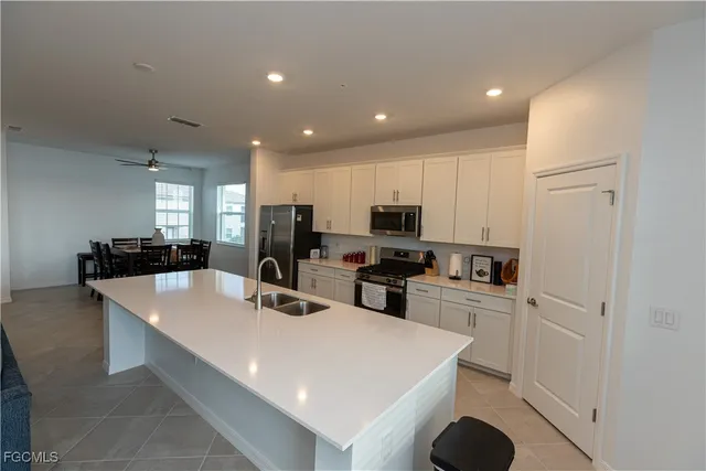a kitchen with sink refrigerator and microwave