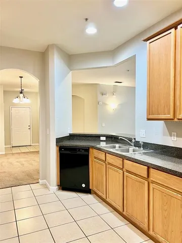 a kitchen with stainless steel appliances a refrigerator sink and microwave