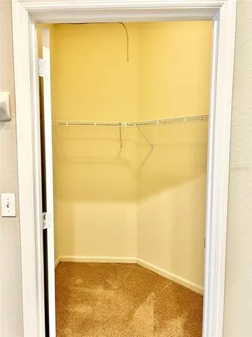 a white toilet sitting next to a white wall