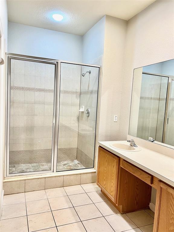 3341 Whitestone Circle, Unit 108 Kissimmee, FL 34741 - Photo 22 of 38 a bathroom with a sink a mirror and a shower