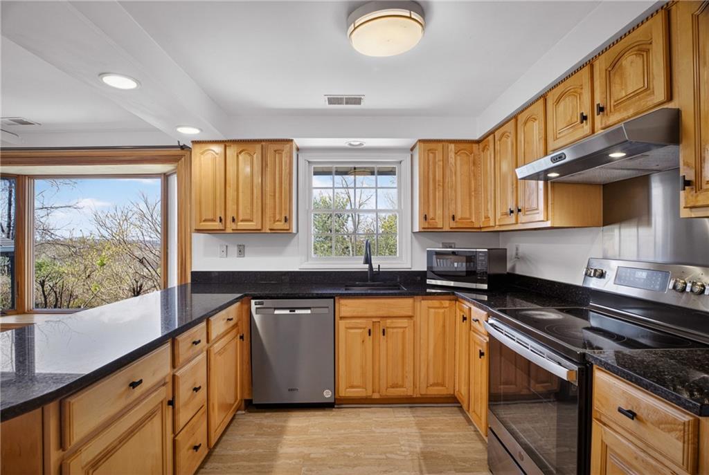 1768 Taper Drive Pittsburgh, PA 15241 - Photo 17 of 48 a kitchen with stainless steel appliances granite countertop a stove a sink and a microwave