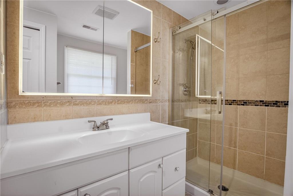 1768 Taper Drive Pittsburgh, PA 15241 - Photo 25 of 48 a bathroom with a shower sink and mirror