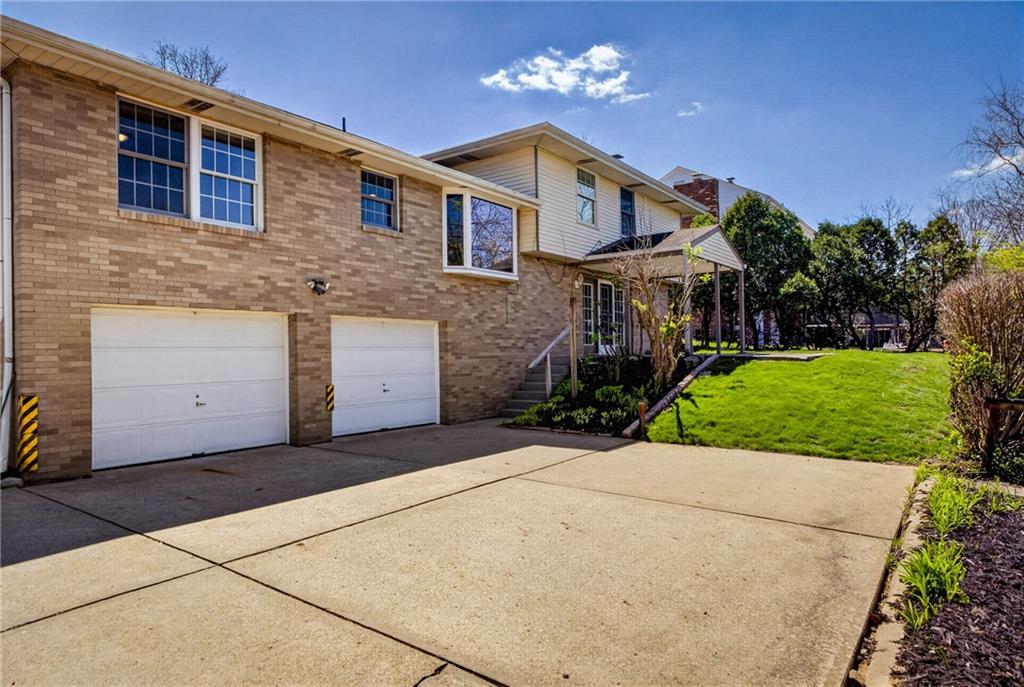 1768 Taper Drive Pittsburgh, PA 15241 - Photo 41 of 48 a front view of a house with a yard and potted plants