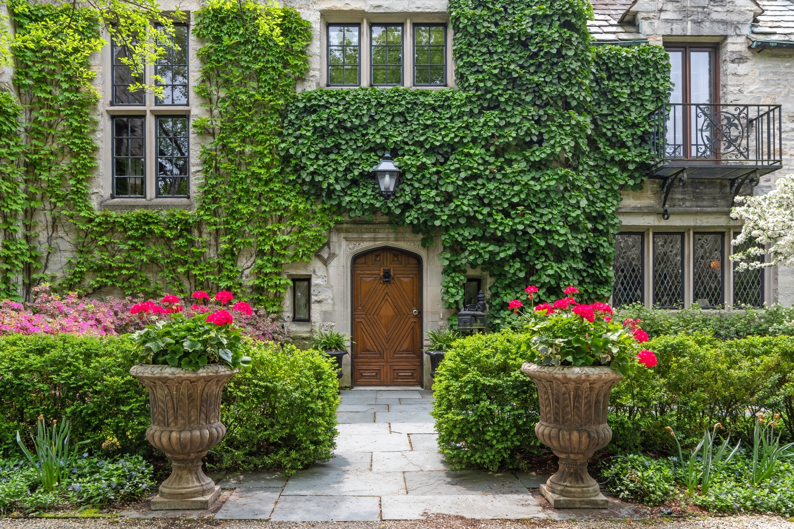 940 Private Road Winnetka, IL 60093 - Photo 2 of 68 a front view of house and yard with beautiful flowers
