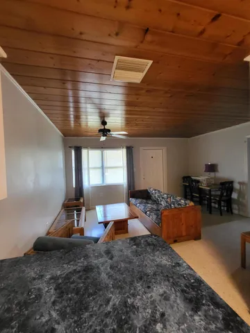 a large room with stainless steel appliances wooden cabinets