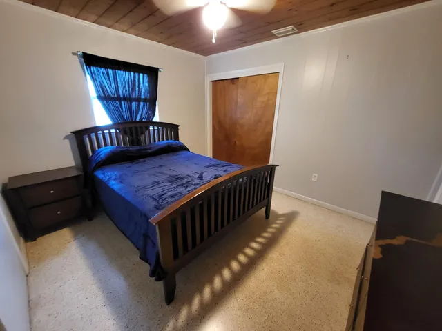 a bed room with furniture and window
