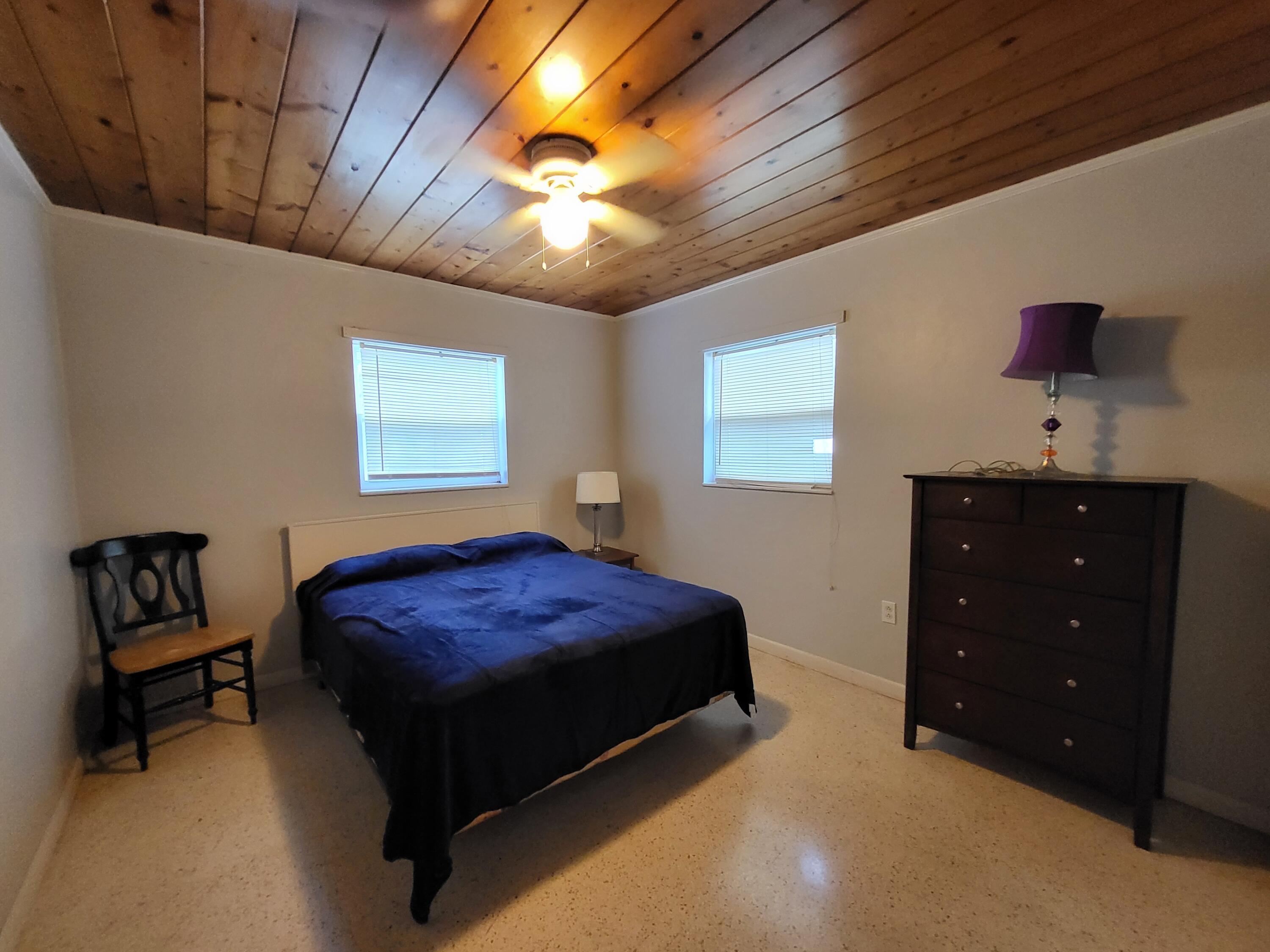 1169 Seaway Drive, Unit B Fort Pierce, FL 34949 - Photo 7 of 8 a bedroom with a bed and a chandelier