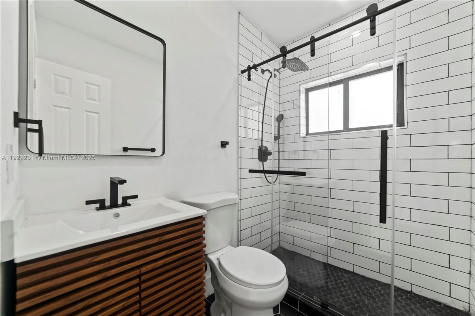 1671 Northeast 174th Street, Unit 1671 North Miami Beach, FL 33162 - Photo 13 of 21 a bathroom with a sink a toilet and shower