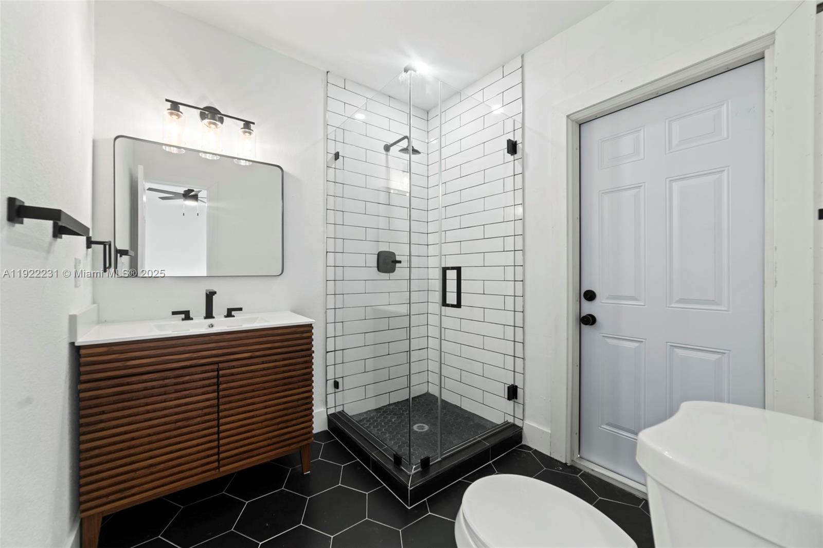 1671 Northeast 174th Street, Unit 1671 North Miami Beach, FL 33162 - Photo 16 of 21 a bathroom with a sink toilet a mirror and shower