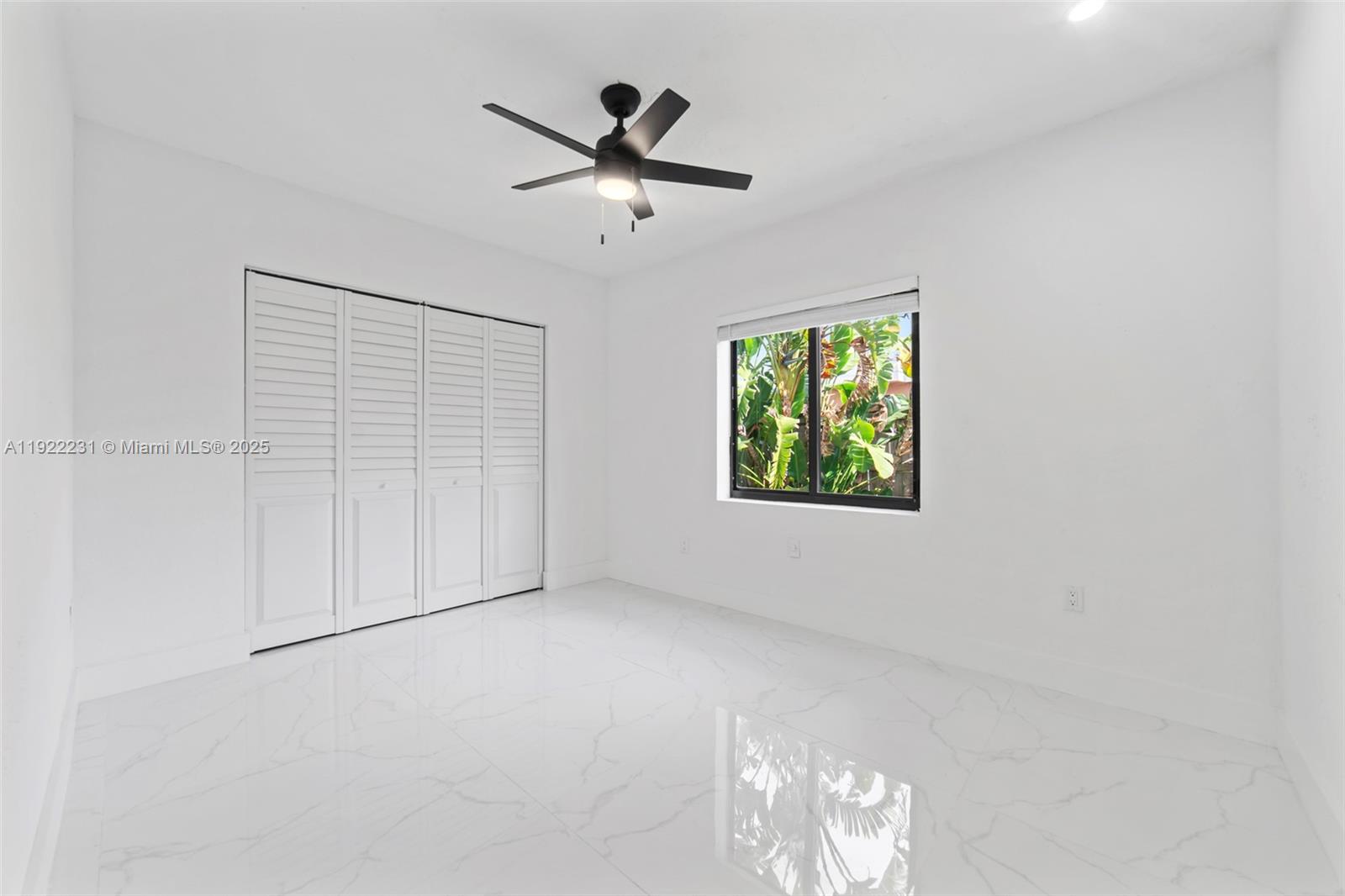 1671 Northeast 174th Street, Unit 1671 North Miami Beach, FL 33162 - Photo 19 of 21 an empty room with windows and ceiling fan