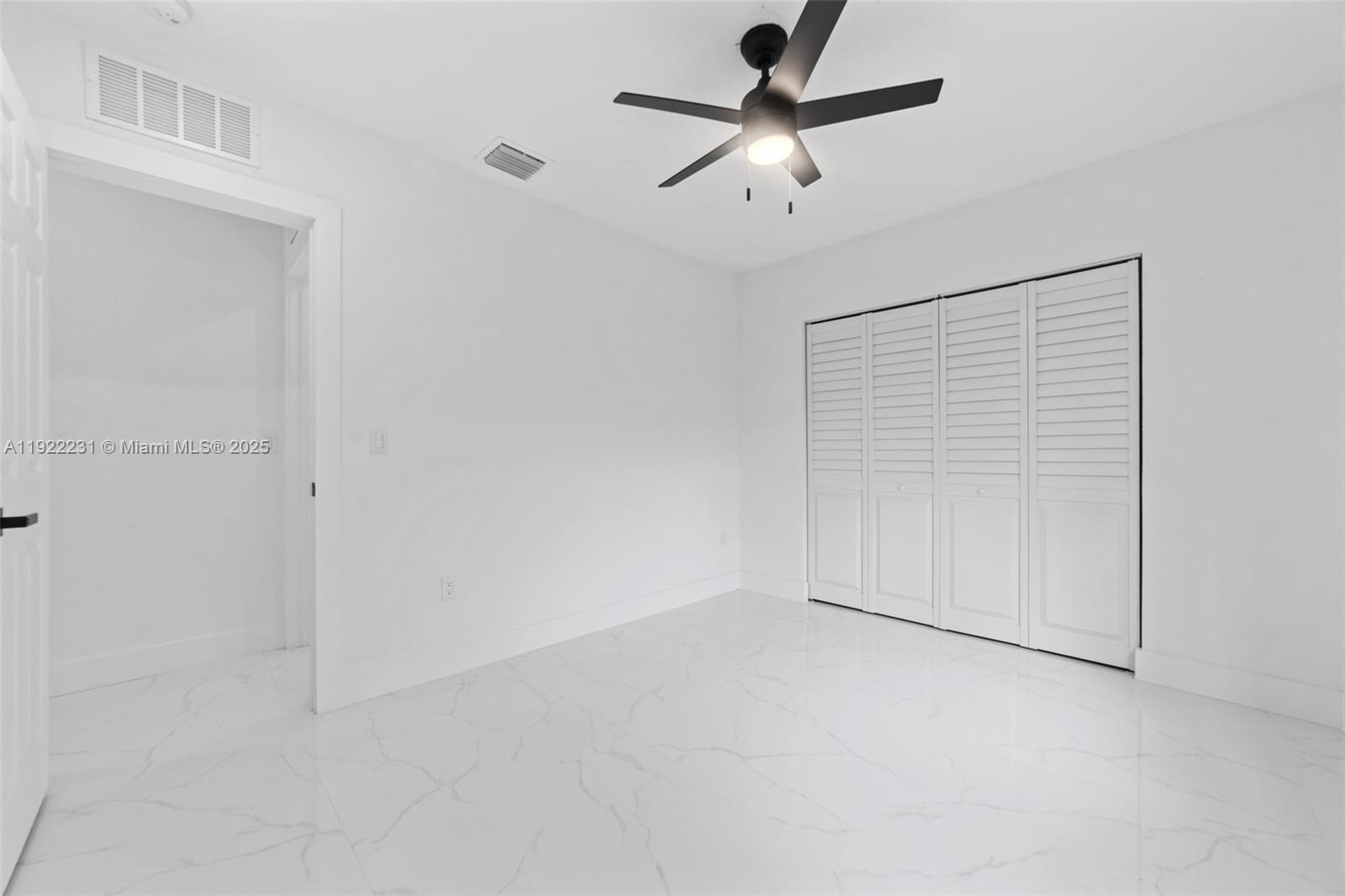 1671 Northeast 174th Street, Unit 1671 North Miami Beach, FL 33162 - Photo 20 of 21 en empty room with ceiling fan